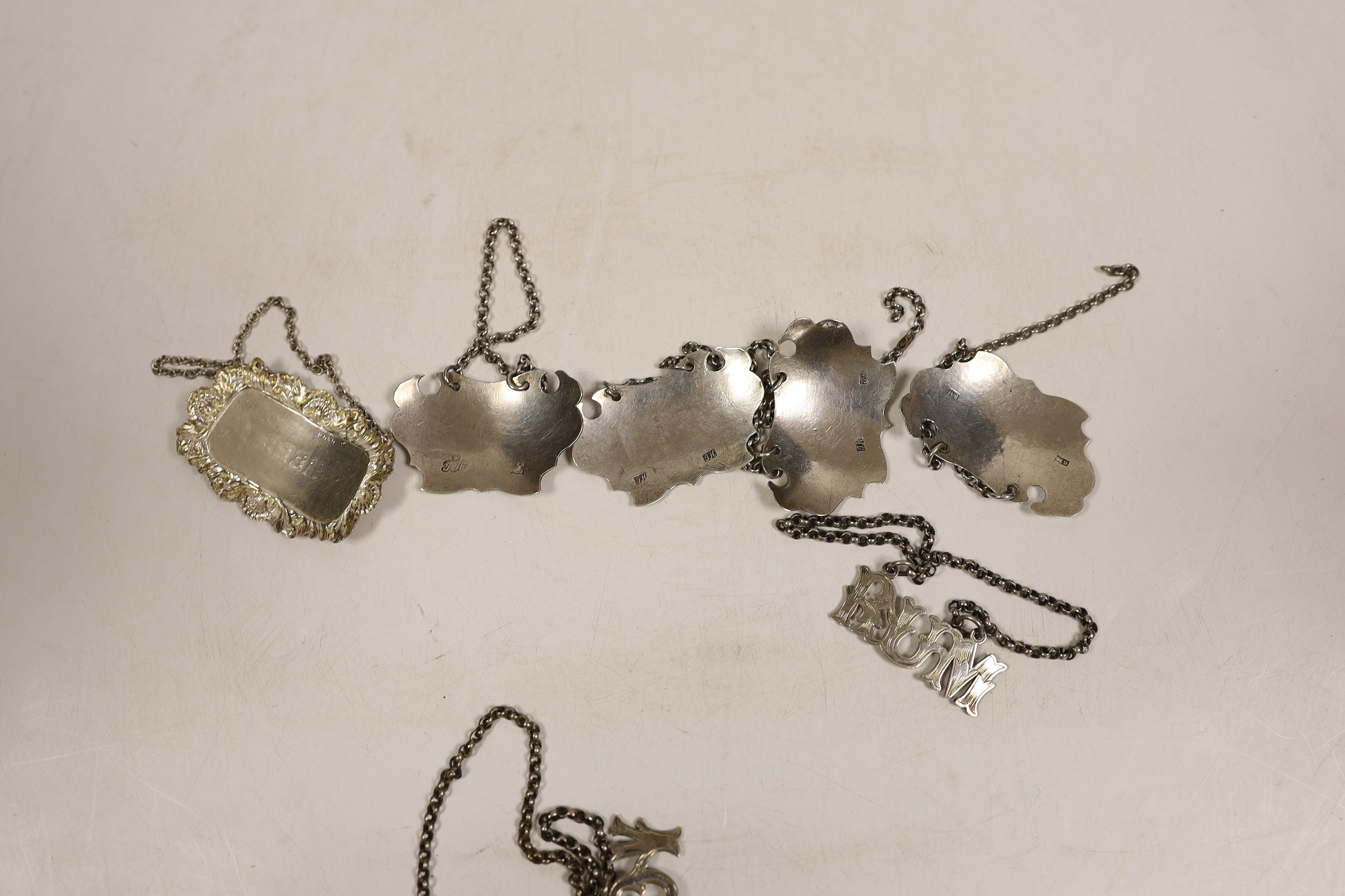 Four assorted 19th century white metal wine labels including pair 'Calcavella' & 'Port' by John Harvey I, London, circa 1750 and four assorted plated wine labels.